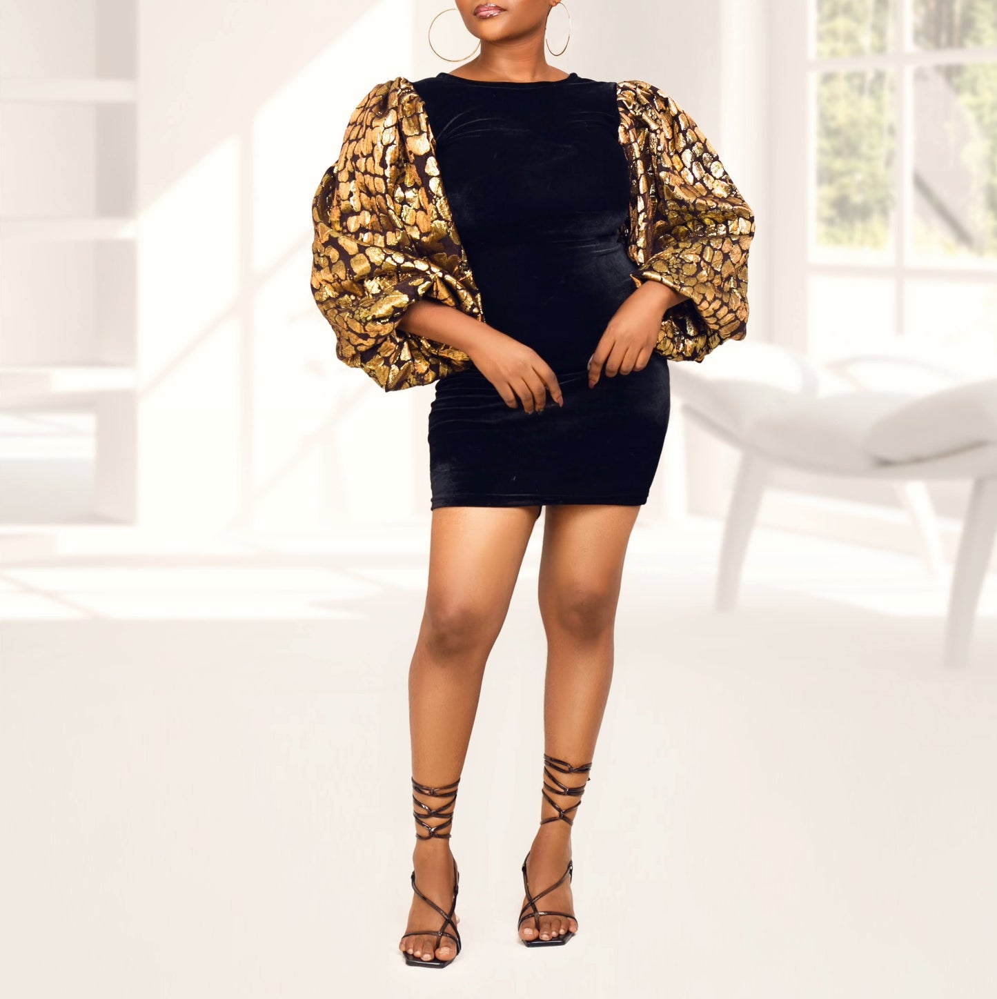 Crush black dress with gold sleeves model standing